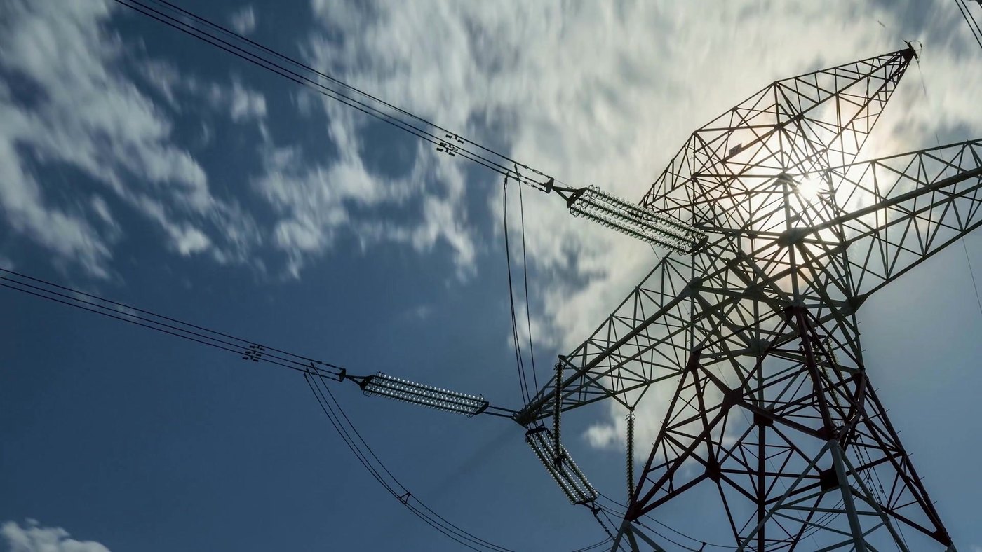 Power transmission lines against a bright sky